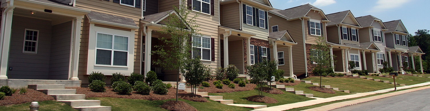 family sitting on the floor with moving boxes