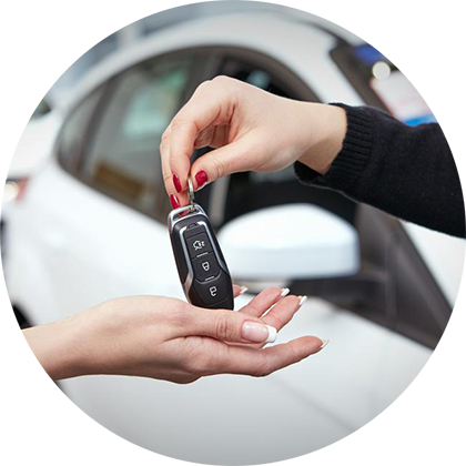 keys being handed to someone who just bought a car